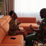 A couple having an emotional discussion on a sofa, working through distance