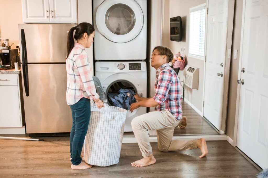 Couple working together on household chores and sharing the mental load in their relationship