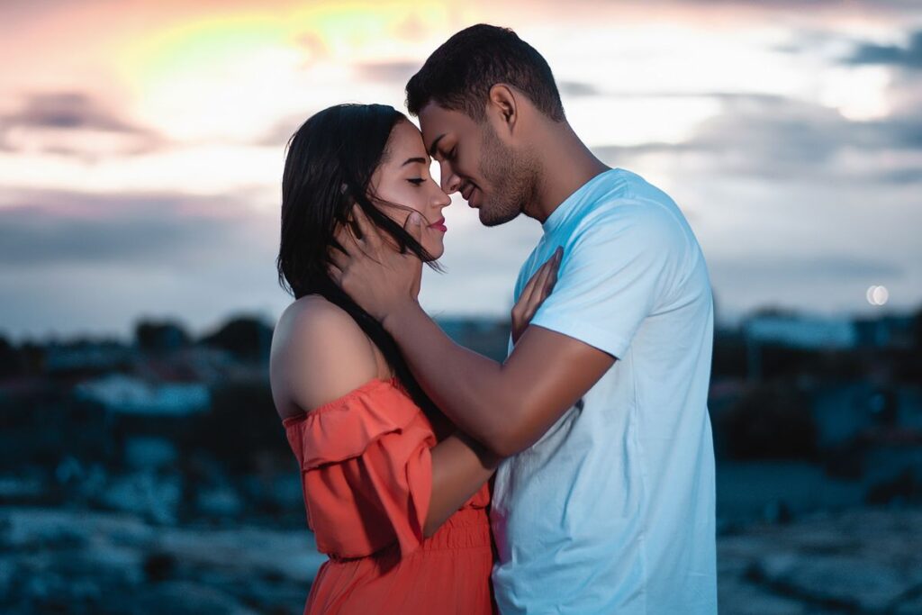 A loving couple embraces during a beautiful sunset outdoors, symbolizing romance and togetherness – navigating different love languages