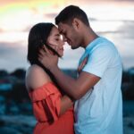 A loving couple embraces during a beautiful sunset outdoors, symbolizing romance and togetherness – navigating different love languages