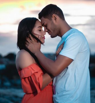 A loving couple embraces during a beautiful sunset outdoors, symbolizing romance and togetherness – navigating different love languages